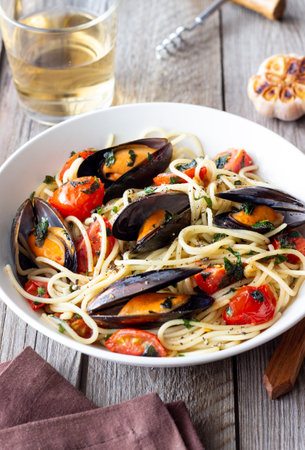 Spaghetti pasta with mussels, tomatoes, garlic and herbs. Healthy eating. Italian foodの写真素材