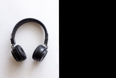 Black headphones on a black and white background. Minimal concept. Mock-up. Music.の写真素材