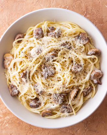 Spaghetti pasta in creamy sauce with mushrooms and cheese. Vegetarian food. Italian cuisine.の写真素材