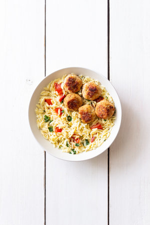 Orzo pasta with chicken meatballs, tomatoes and herbs. Italian foodの写真素材