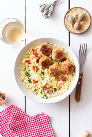 Orzo pasta with chicken meatballs, tomatoes and herbs. Italian foodの写真素材