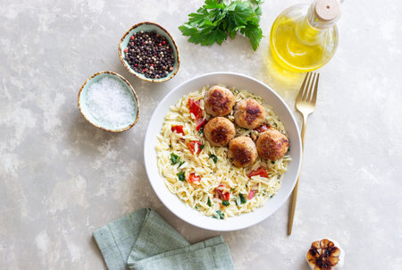 Orzo pasta with chicken meatballs, tomatoes and herbs. Italian foodの写真素材