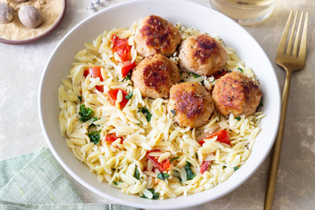 Orzo pasta with chicken meatballs, tomatoes and herbs. Italian foodの写真素材