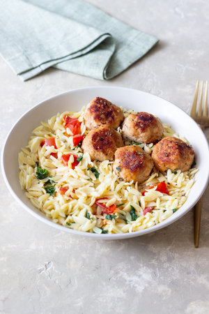 Orzo pasta with chicken meatballs, tomatoes and herbs. Italian foodの写真素材