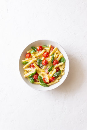 Pasta casarecce with tomatoes, basil and cheese. Italian cuisine. Vegetarian foodの写真素材