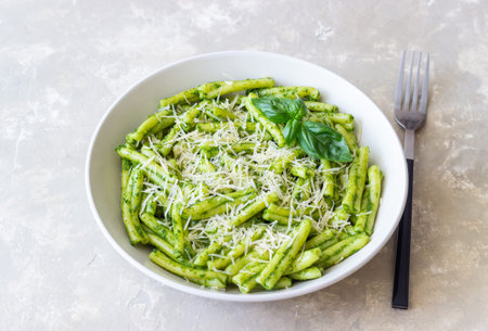 Pasta casarecce with pesto sauce, basil and cheese. Italian cuisine. Vegetarian food