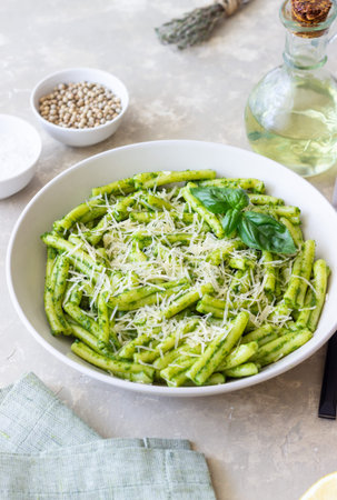 Pasta casarecce with pesto sauce, basil and cheese. Italian cuisine. Vegetarian food