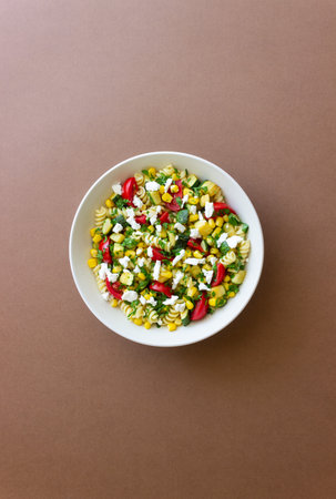 Pasta salad with tomatoes, zucchini, corn and feta cheese. Healthy eating. Vegetarian food.の写真素材