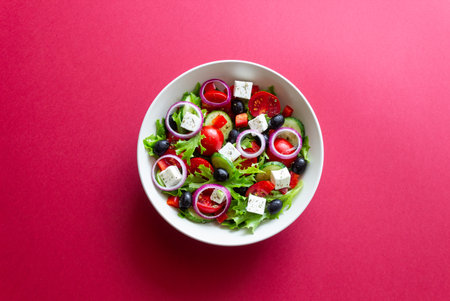 Greek salad with feta cheese, tomatoes, onion, cucumbers, peppers and olives. Healthy eating. Vegetarian foodの写真素材