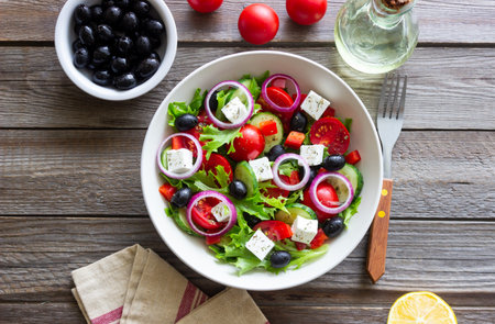 Greek salad with feta cheese, tomatoes, onion, cucumbers, peppers and olives. Healthy eating. Vegetarian foodの写真素材