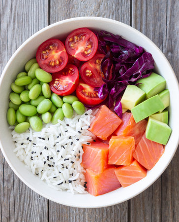 Poke bowl with rice, salmon, avocado, red cabbage, edamame and tomatoes. Healthy food. Diet