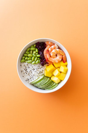 Hawaiian poke bowl with rice, shrimp, red cabbage, radish, edamame, and mango. Healthy eating. Diet