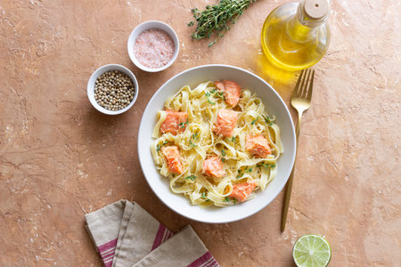 Pasta fettuccine in a creamy sauce with salmon, cheese and thyme. Italian cuisine. Healthy eatingの写真素材