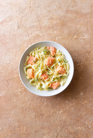 Pasta fettuccine in a creamy sauce with salmon and cheese. Italian cuisine.の写真素材