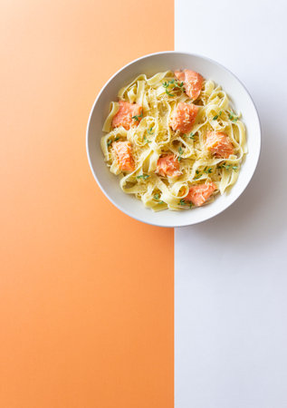 Pasta fettuccine in a creamy sauce with salmon, cheese and thyme. Italian cuisine. Healthy eatingの写真素材