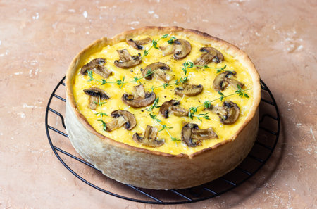 Quiche or open pie with mushrooms, cheese, and thyme. French cuisine. Vegetarian food