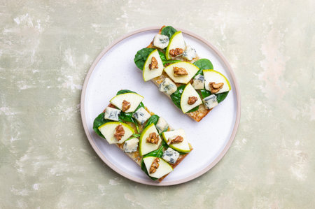Bruschetta with spinach, honey, blue cheese, pear, and nuts. Healthy eating. Vegetarian foodの写真素材