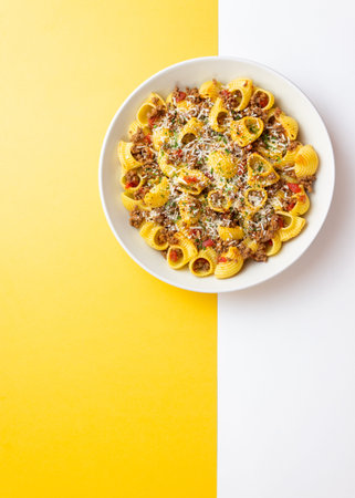 Pasta with bolognese sauce and cheese. Italian cuisine. Traditional recipe