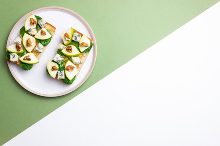 Bruschetta with spinach, honey, pear, and nuts. Healthy eating. Vegetarian foodの写真素材