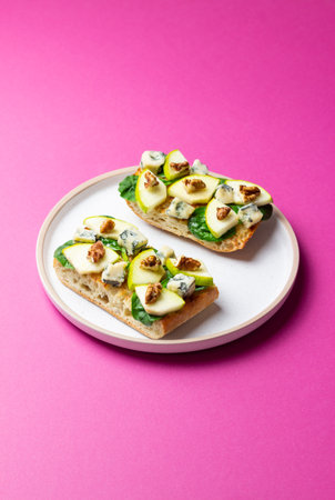 Bruschetta with spinach, honey, blue cheese, pear, and nuts. Vegetarian foodの写真素材