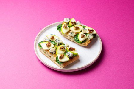 Bruschetta with spinach, honey, blue cheese, pear, and nuts. Healthy eating. Vegetarian foodの写真素材