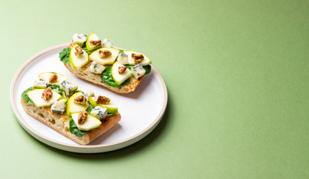 Bruschetta with spinach, honey, blue cheese, pear, and nuts. Healthy eating. Vegetarian foodの写真素材
