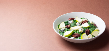 Salad with spinach, blue cheese, pear, and nuts. Healthy eating. Vegetarian food.の写真素材