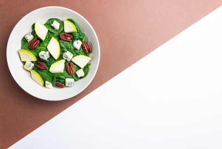 Salad with spinach, blue cheese, pear, and nuts. Healthy eating. Vegetarian food.の写真素材