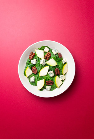 Salad with spinach, blue cheese, pear, and nuts. Healthy eating. Vegetarian food.の写真素材