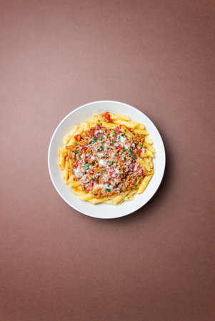 Pasta with bolognese sauce and cheese. Italian cuisine. Traditional recipe