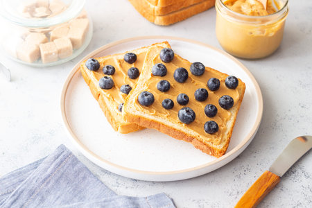 Sandwich with peanut butter and blueberries. Breakfast. Vegetarian food