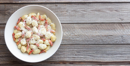 Gnocchi in a creamy sauce with bacon and cheese. Italian cuisine