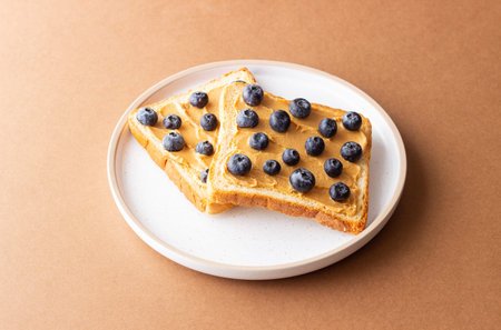 Sandwich with peanut butter and blueberries. Breakfast. Vegetarian food