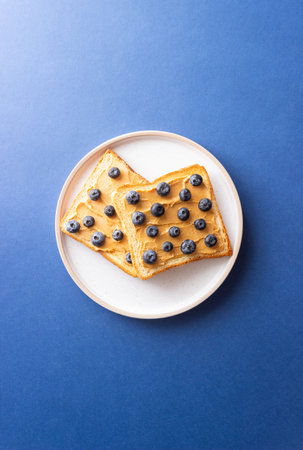 Sandwich with peanut butter and blueberries. Breakfast. Vegetarian food