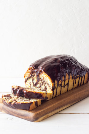 Marble loaf cake glazed with chocolate. Vegetarian food. Bakery