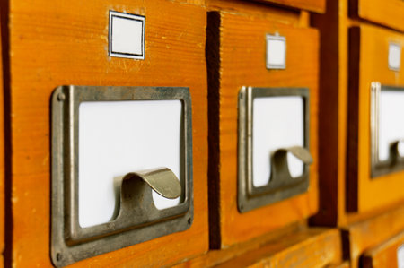Close-up of a wooden old vintage shelf of file cabinets in a library. Sorting, organizing, knowledgeの写真素材