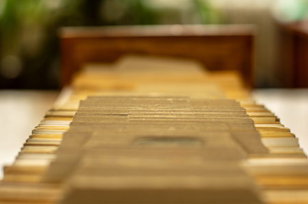Close up of old paper cards in wooden old file cabinet on blurred background. Arrangement of...