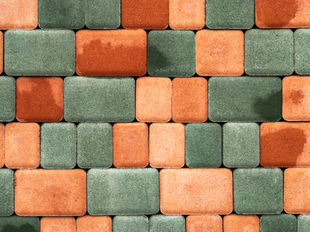 Background of wet orange and green paving stones, pattern. Design and architecture conceptの写真素材