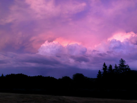 Landscape of purple and pink majestic clouds in the sky at dusk. The concept of the beauty of natureの写真素材