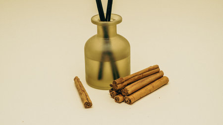 A beautifully arranged collection of cinnamon sticks paired gracefully with a diffuser to enhanceの写真素材