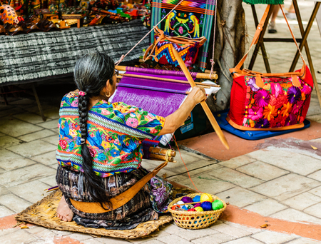 Woman weaving in an old village in Guatemala.  Traditional waver from Guatemala.の写真素材