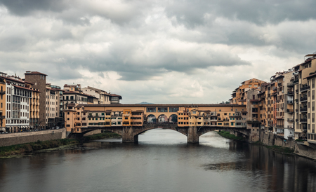 Travel photo of Ponte Vecchio bridge over the Arno River in Florence Italiy. Colorful bridge over the river in Florence.の写真素材