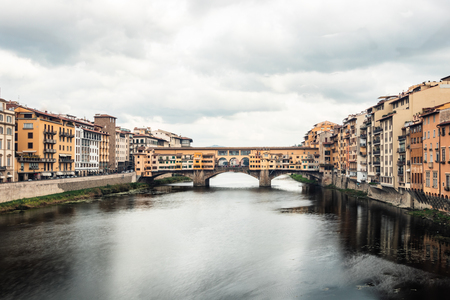 Travel photo of Ponte Vecchio bridge over the Arno River in Florence Italiy. Colorful bridge over the river in Florence.の写真素材