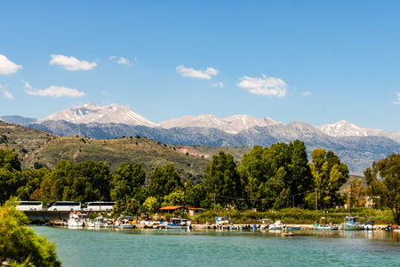The town Georgioupoli, Crete, Greece and snowy White Mountain Range, Agios Nikolaos.の写真素材