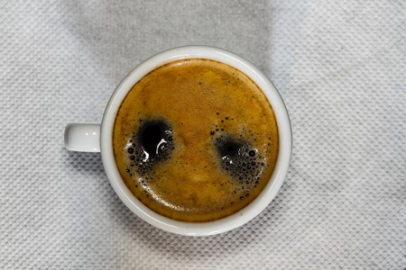 Cup of Espresso coffee on white napkin, espresso creme.の写真素材