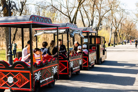Bucharest, Romania 2019. Tourists taking a train ride on the alleys of Mogosoaia Park.のeditorial素材