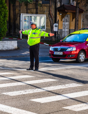 Targoviste, Romania - 2019. Police officer directing traffic in downtown junction in Targoviste...