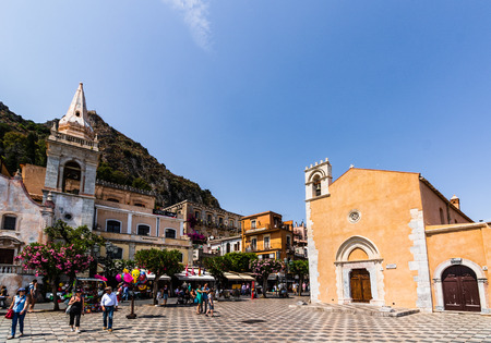 Taormina, Italy - 2019. Tourists walking on ancient street with old buildings.のeditorial素材