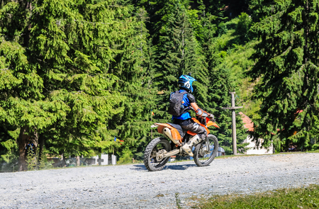 Iezer Mountains - Romania - 2019. Young biker having a ride in the forest of Iezer Mountains on a cross motorbikeのeditorial素材