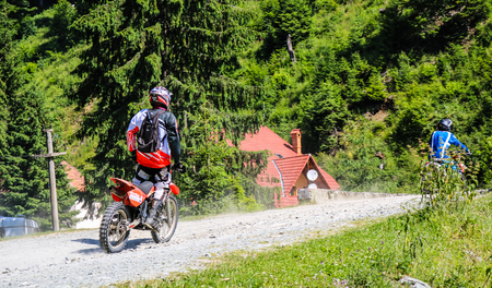 Iezer Mountains - Romania - 2019. Young biker having a ride in the forest of Iezer Mountains on a cross motorbikeのeditorial素材